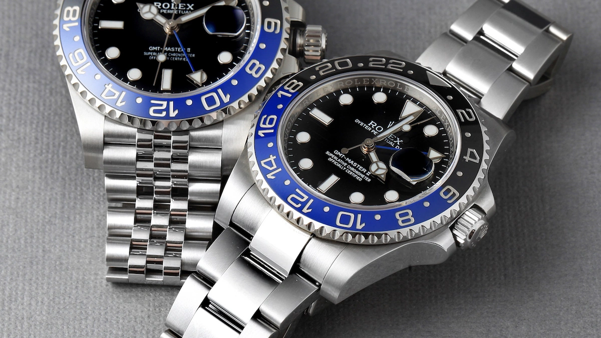 Two blue-and-black-bezel GMT-Master II watches, one with a Jubilee bracelet and one with an Oyster bracelet.